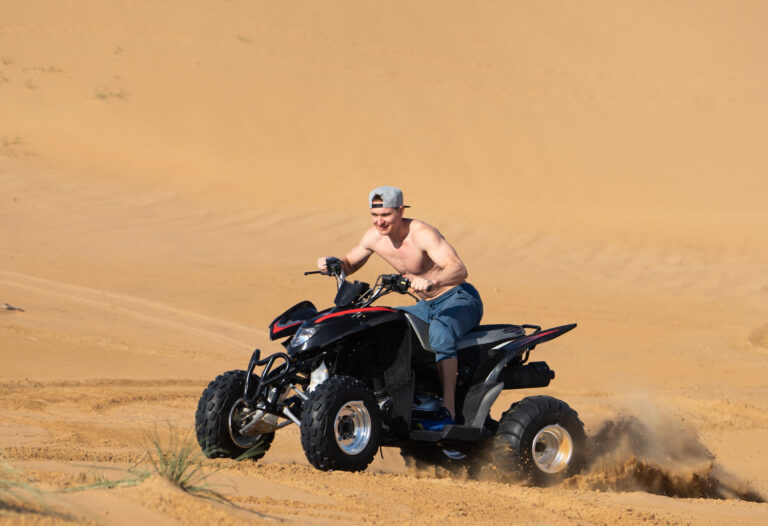 Muscular Man topless Riding Atv In the Desert.